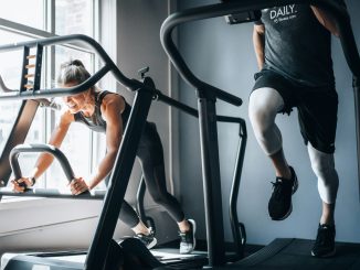 woman in black tank top and black shorts sitting on black exercise equipment